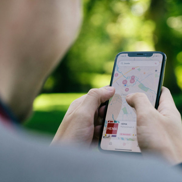 A man using an iPhone to show a map